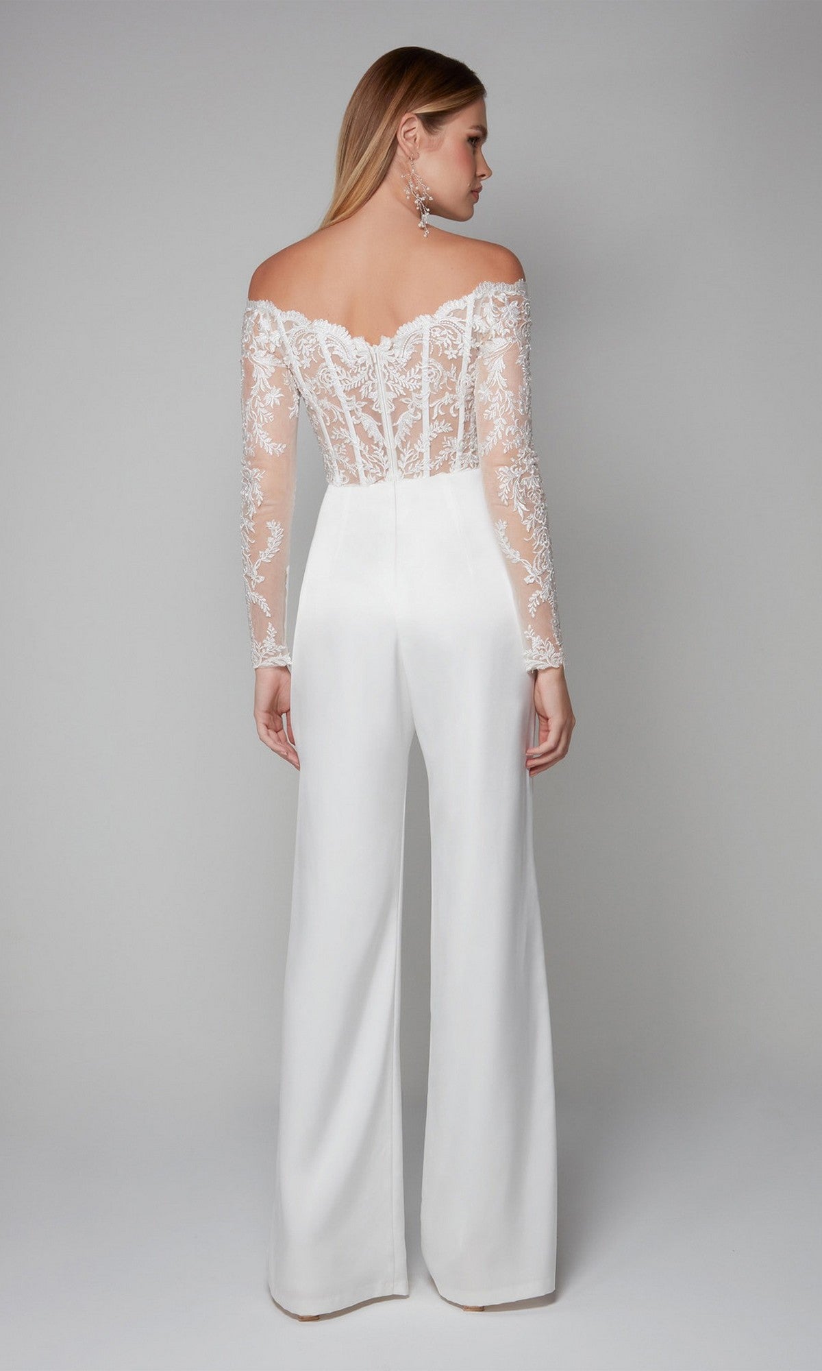 Model wears the Alyce 70018 Long Formal Jumpsuit featuring off-the-shoulder lace embroidery, sheer long sleeves, and wide-leg pants, shown from the back against a plain background.